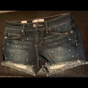 Denim shorts with pearls.